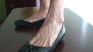 Veiny feet in the world wearing flats on the table