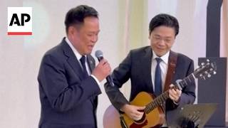 Thailand and Singapore prime ministers perform Beatles song together