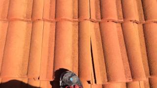 Roof in nice area has two tiles misplaced.