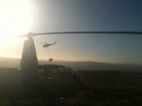 Helicopters collecting bags of heather cuttings above Old Glossop