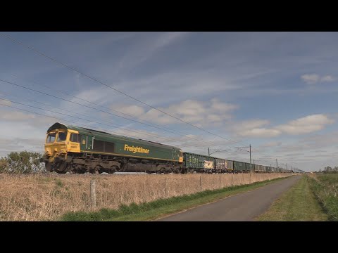 Freightliner 66603 hauls a heavy aggregates train past Stretham