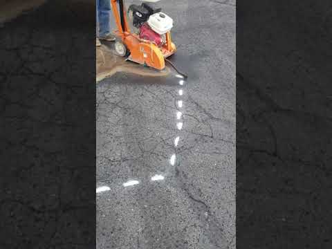 Using our Norton walk behind saw for cutting asphalt