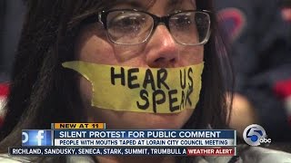 Lorain residents tape mouths shut in protest