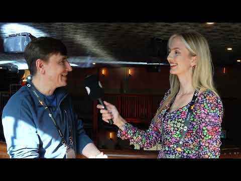 Evgeny Bareev, Canada's #1 player, chats with Charlize van Zyl in the fan zone of the Candidates