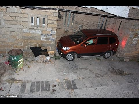 Man squeezes his car into the tightest of spots as crowds gather to witness the incredible effort