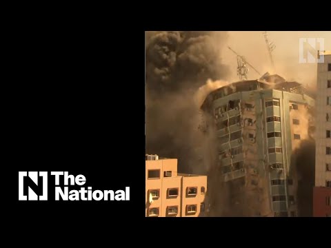 Watch the moment the Gaza media tower collapses after Israeli air strike