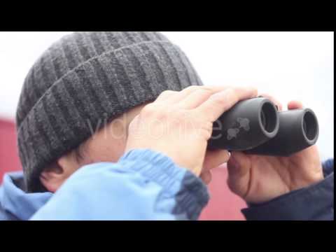 Man With Binoculars Looking Around