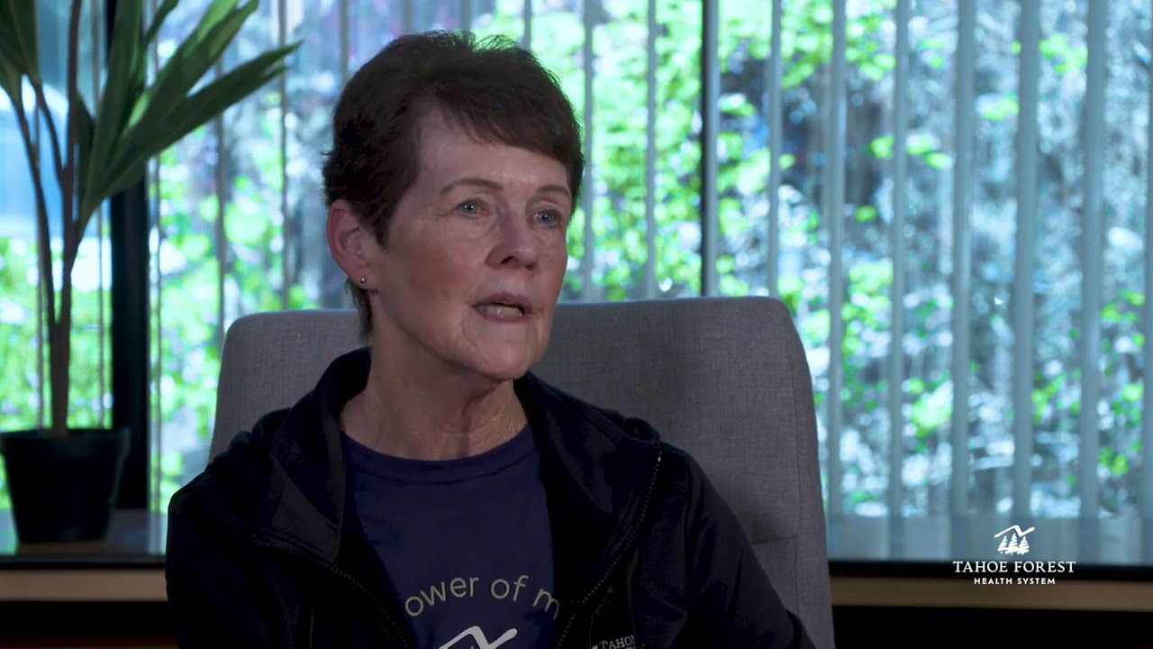 Bernice Zander, Director of Health Information Management, sitting in front of a window