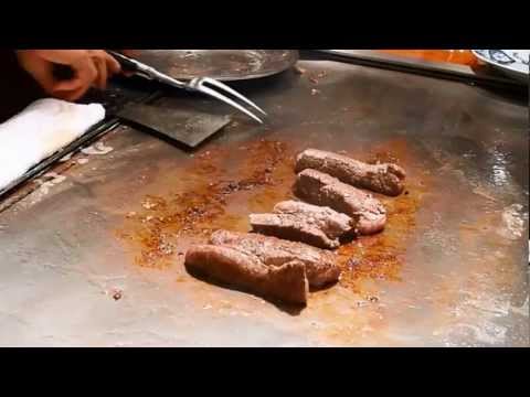 Chef preparing Kobe Beef and sides at Steak Land in Kobe, Japan