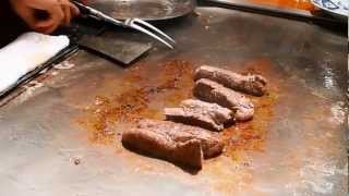 Chef preparing Kobe Beef and sides at Steak Land in Kobe, Japan