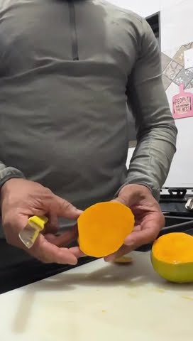 Slicing into a ripe Ratnagiri Alphonso