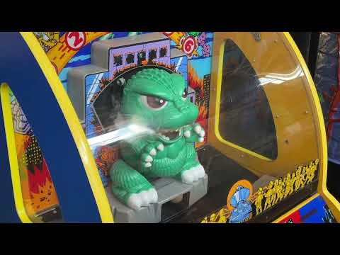 Nate and Beth playing Godzilla Wars Jr. at an arcade