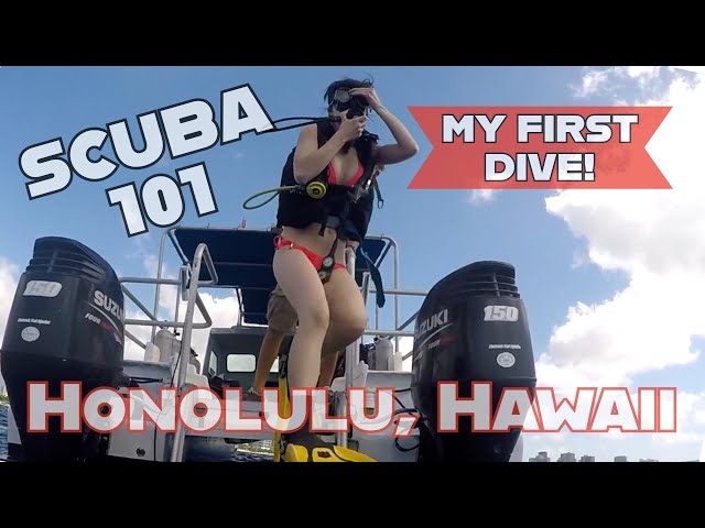 Five divers sitting on the edge of a dive boat practicing SCUBA skills with an instructor.