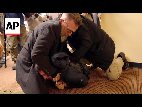 Video Thumbnail: Man tackled after spraying unknown substance on Rep. Ilhan Omar at town hall in Minneapolis