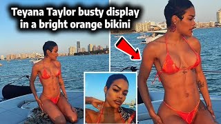 Teyana Taylor puts on a busty display in a bright orange bikini and shows off her washboard abs