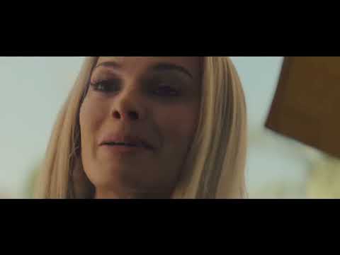 Official trailer still — neon Los Angeles at dusk as radio chatter fades up