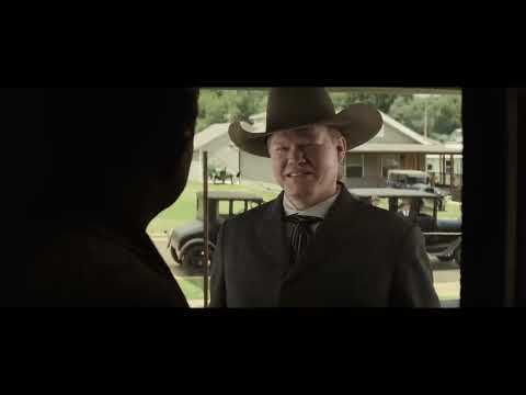 Trailer collage: stoic faces, ledgers, and oil derricks—music maps ritual to power