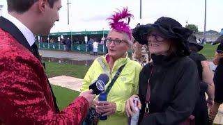 Josh Ninke talks to visitors from South Dakota having a bachelorette party in the infield