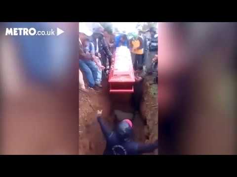 Woman's body falls out of coffin during funeral after pallbearer falls on top