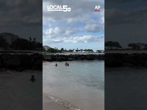 Ancient Hawaiian petroglyphs on a beach are visible again with changing tides and shifting sands