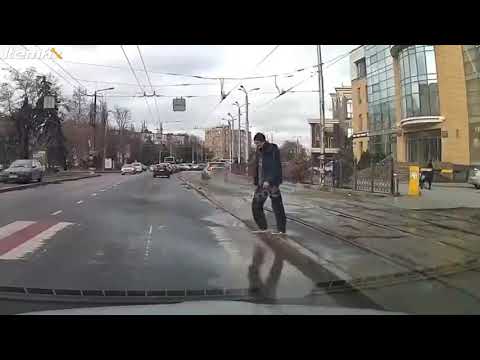 Car splashing puddle on pedestrian