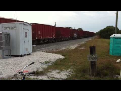 FEC TRAIN 336#587 w/ a swat team truck going over the track after the train