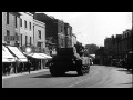 American military trucks and tanks pass through English village of shaftesbury, d...HD Stock Footage