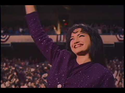 Trailer shot: close-up of stage lights and crowd hands at a Selena concert