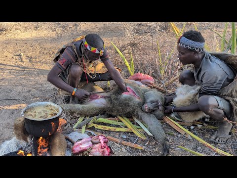 Hadzabe tribe celebrating a successful hunt Baboon and Cooking Lunch.