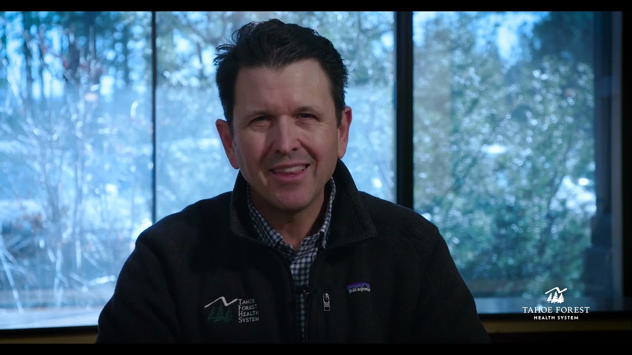 Dr. Brian Evans, Chief Medical Officer, sitting in front of a window.