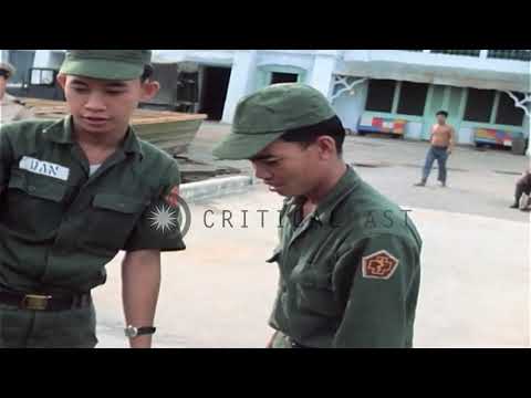 17/09/67 PBR crewmen check ID cards and an injured Vietnamese at the Binh Thuy Air Base,Mekong Delta