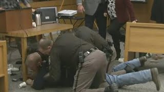 Father of victims lunges at Larry Nassar in court video