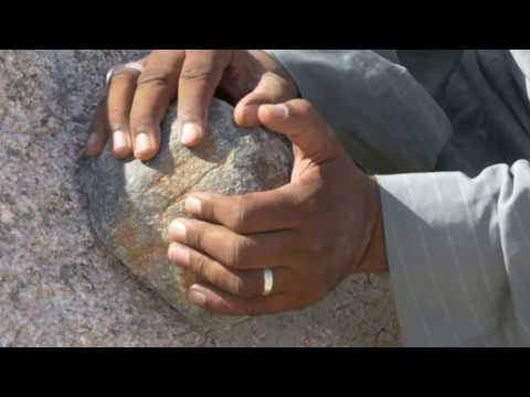Grinding granite with a dolerite stone ball at the Unfinished Obelisk in Aswan, Egypt.