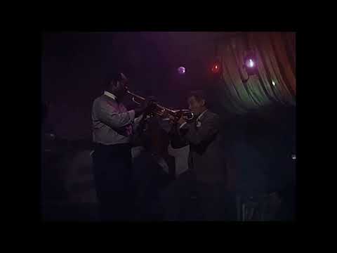 Trailer frame: final ovation feel with band, chorus, and waving crowd in The Five Pennies