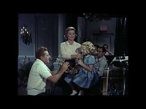 Trailer frame: club bandstand with brass section and spotlighted singer in The Five Pennies