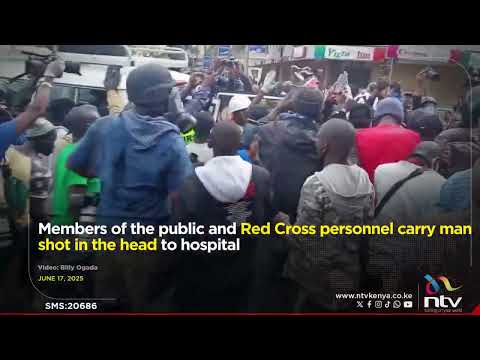 Members of the public and Red Cross personnel carry man shot in the head to hospital