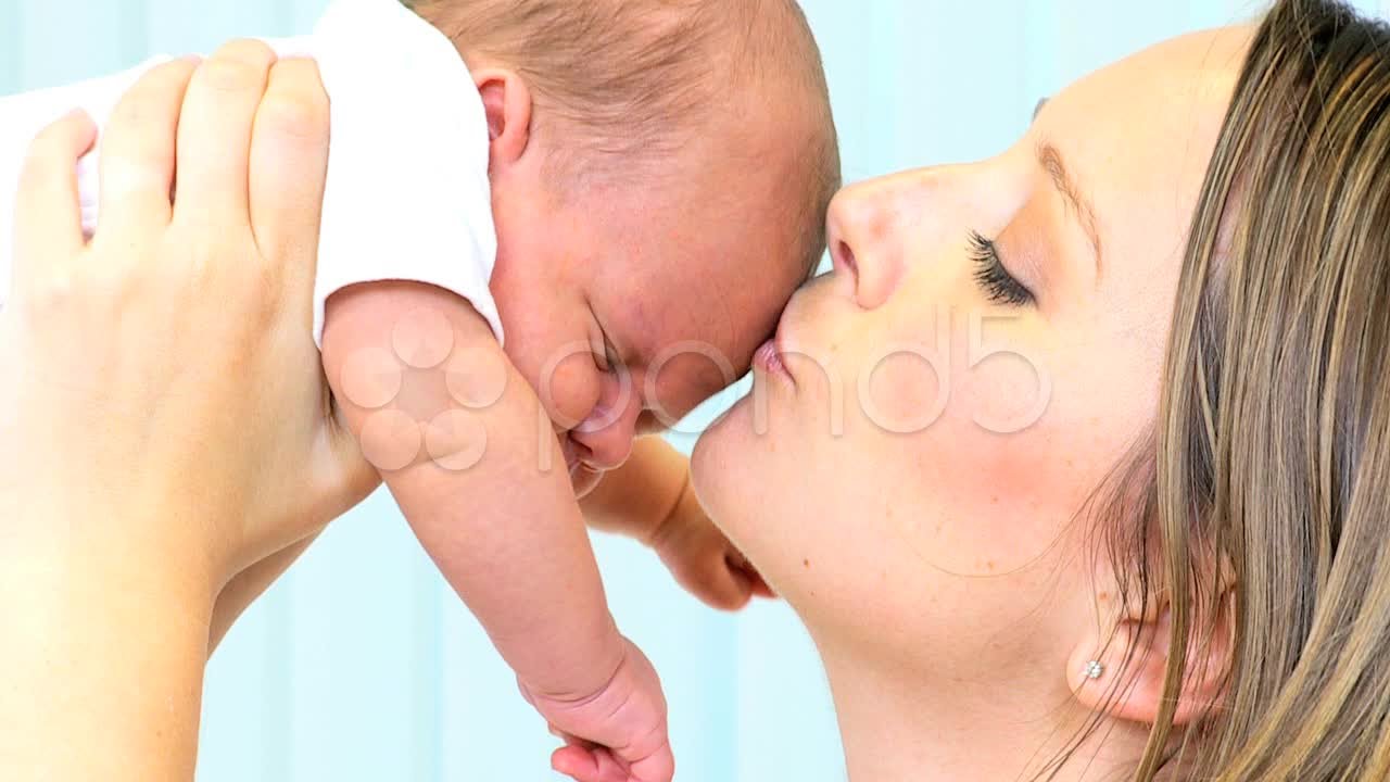 Loving Mother Kissing Baby Daughter. Stock Footage