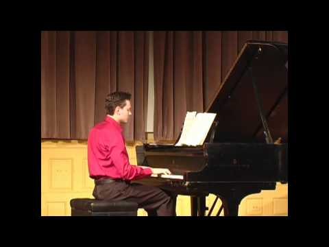 Brett Klaus performing Rzewski’s Winnsboro Cotton Mill Blues in a magenta shirt