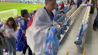 Japan fans clean up the stadium after defeat to Croatia