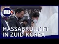 Massabruiloft met mondkapjes in Zuid-Korea | NU.nl