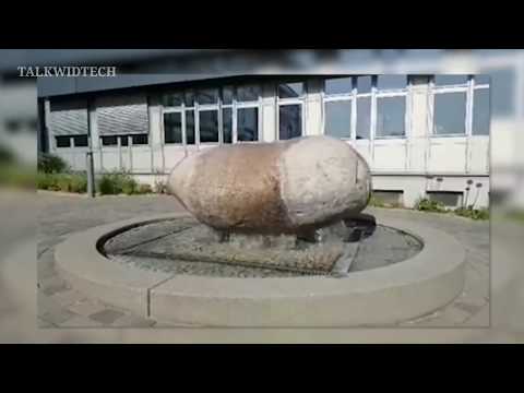 A Massive boulder slipping around on top of a Fountain