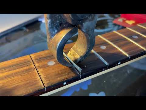 How to safely remove frets from a guitar neck and avoid chipping the wood.