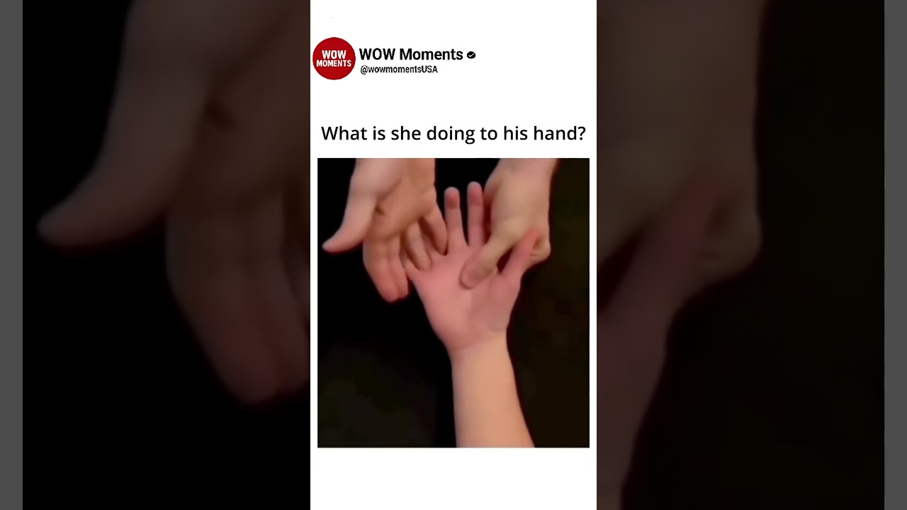 What is she doing to his hand?