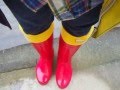 happy rainy day with red rain boots 
