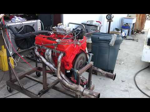 327 Chevy Edelbrock 2201 rollin thunder cam aluminum heads painted to look stock open header run.
