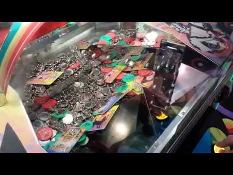 crazy gambling addict plays Wizard of Oz coin pusher game at nickel arcade