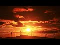 An Orange color Sunset behind the Windmills/ Orange dusk / Orange Sunset - 4k Video Seductive Nature