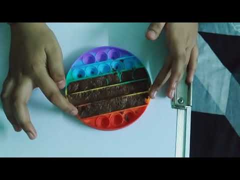 Nishtha and Nirmayee making Pop it shape chocolate