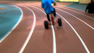 Aaron riding on two wheels on a tricycle