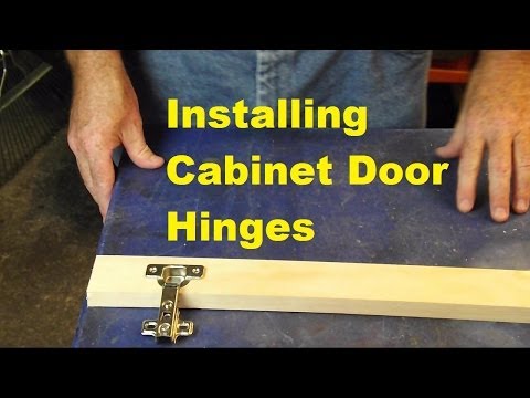 Installing cabinet door hinges.